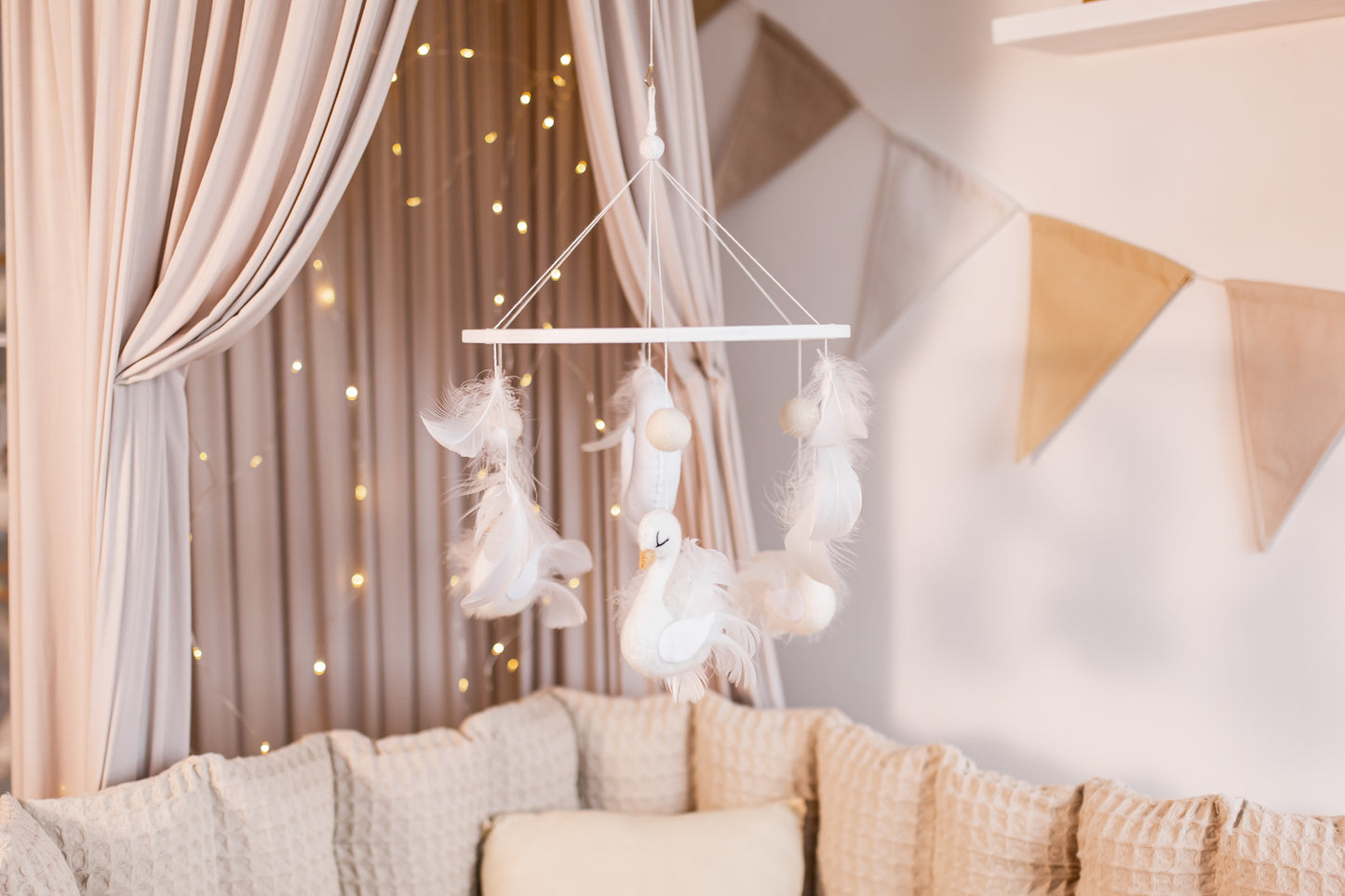 Decorative mobile hanging above a sofa with soft lighting and neutral colors