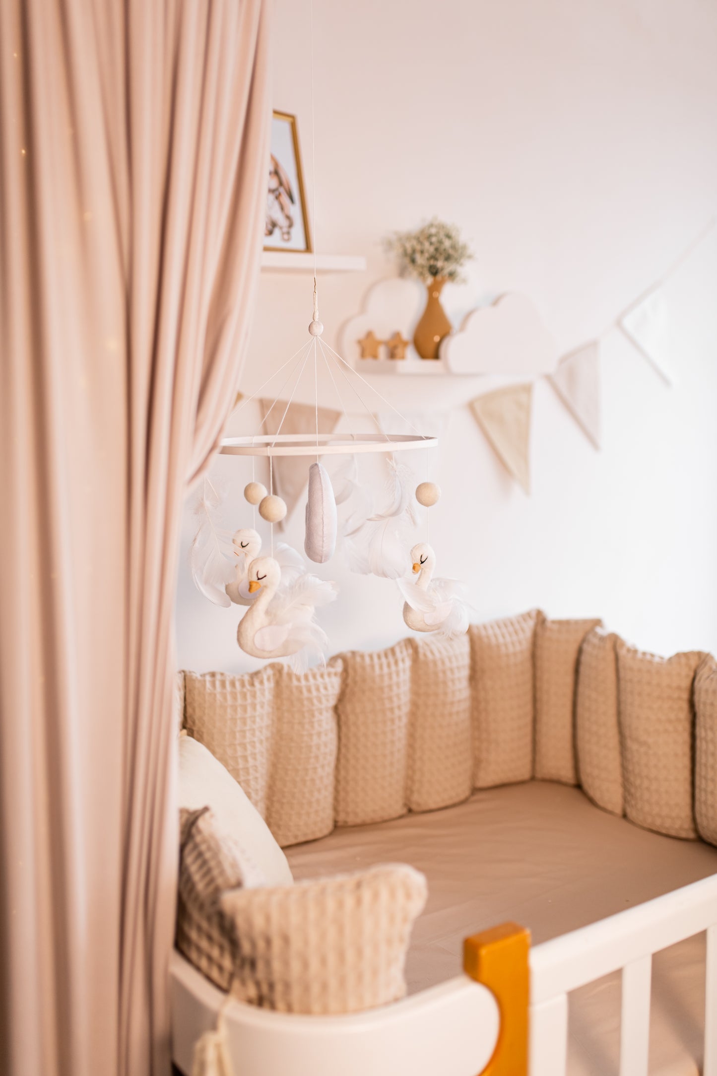 Children's room with a canopy bed, swan baby mobile, soft lighting, and decorative elements.