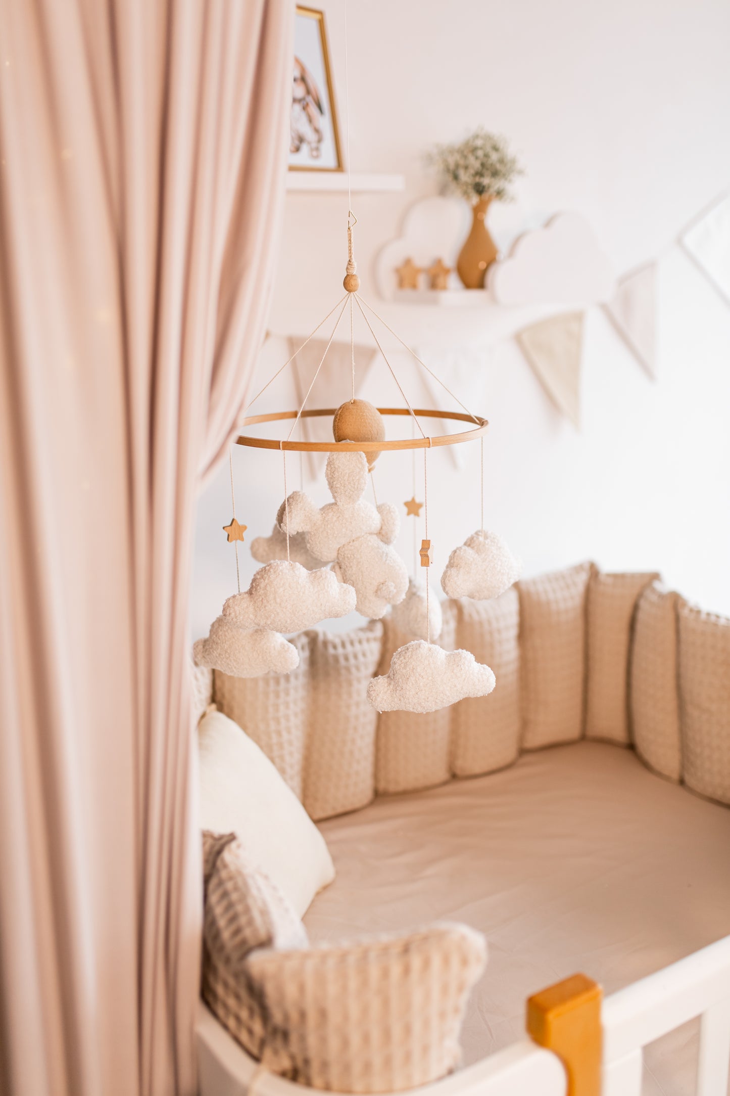 Children's room with a crib, baby mobile, canopy, and decorative items.