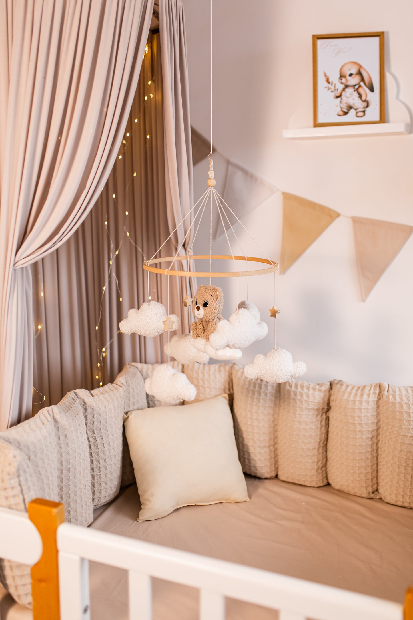 Nursery room with a cozy baby mobile, soft lighting, and decorative elements.