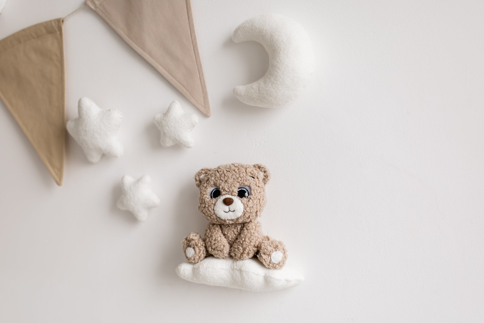 Whimsical bouclé bear wall décor with soft lighting—perfect for nursery design